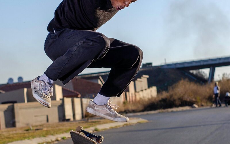 Skateboarder mid-air over a ramp
