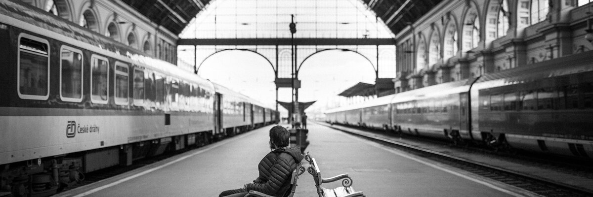 Passenger waiting on a platform between two trains