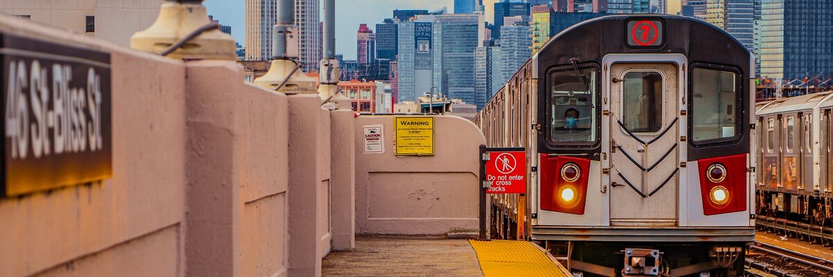 Subway platform framed beneath an arched tunnel ceiling