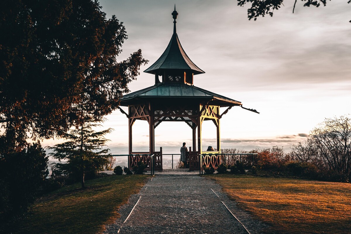 Hilltop gazebo overlooking a valley at sunset