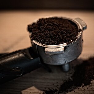 Portafilter packed with fresh espresso grounds