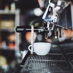 Espresso shot pulling into a white cup