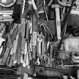Overhead view of a workbench covered in hand tools