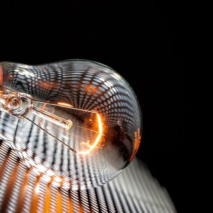 Glowing incandescent bulb against a dark background
