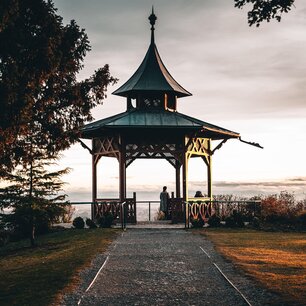 Hilltop gazebo overlooking a valley at sunset