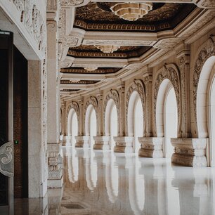 Ornate marble corridor lined with arches