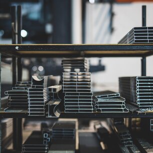 Stacked metal parts on warehouse shelving