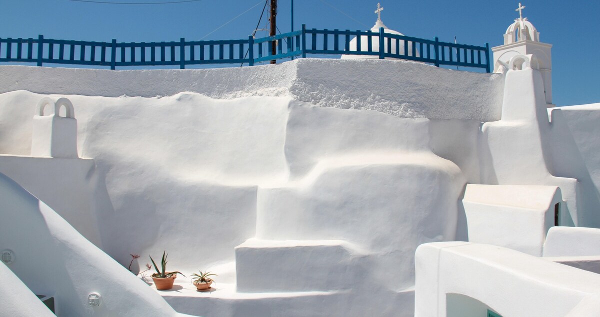Whitewashed cliffside village overlooking the sea