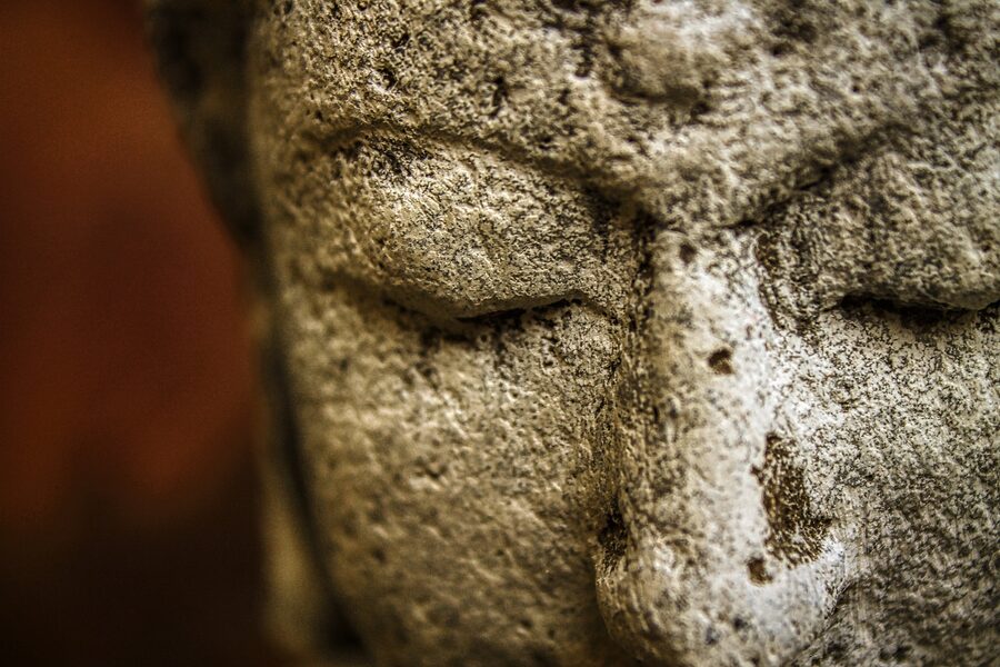 Extreme close-up of a weathered stone statue face