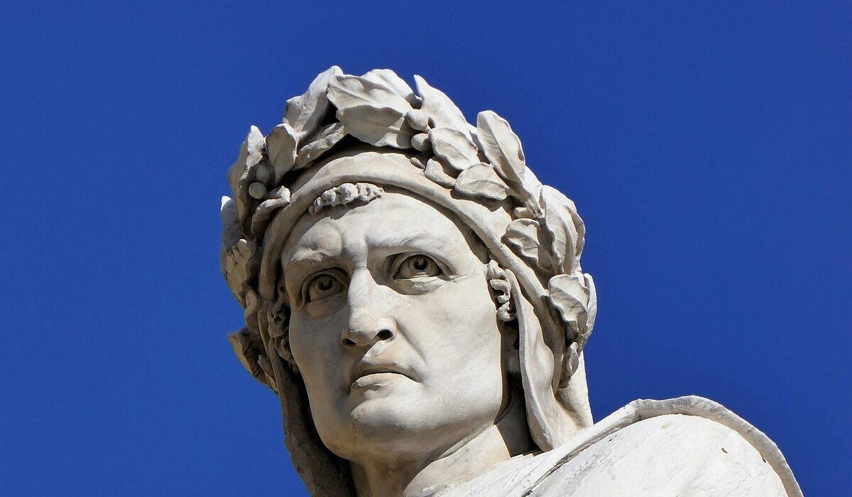 Marble statue of Dante crowned with a laurel wreath against a blue sky